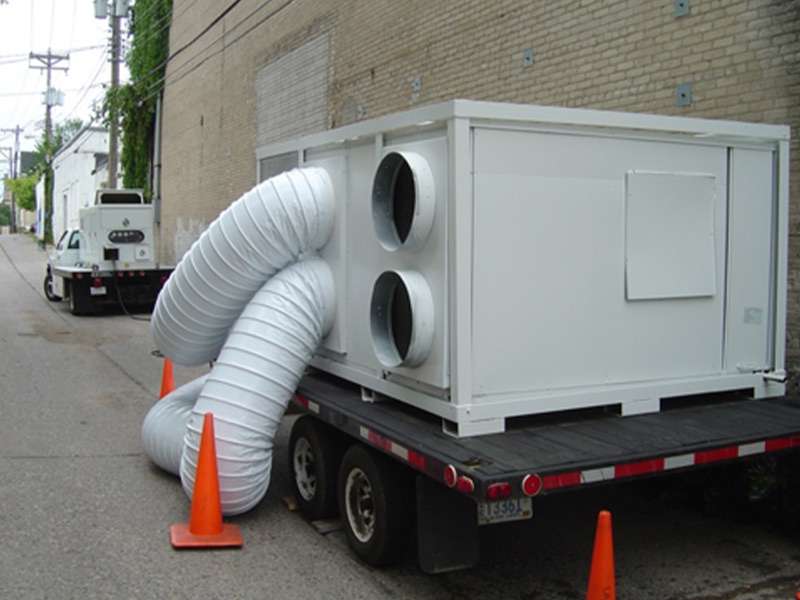 Portable industrial HVAC unit on a flatbed truck for commercial rental services.