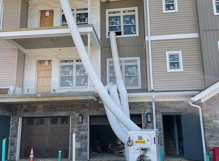 Construction site of residential building with HVAC ductwork in progress.