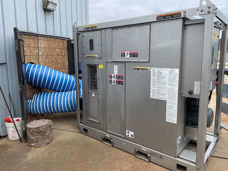 Heavy industrial HVAC unit with flexible ductwork for commercial or rental property use.
