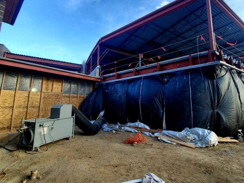 Construction site with temporary housing or office space in progress, showcasing renovation for rental properties.