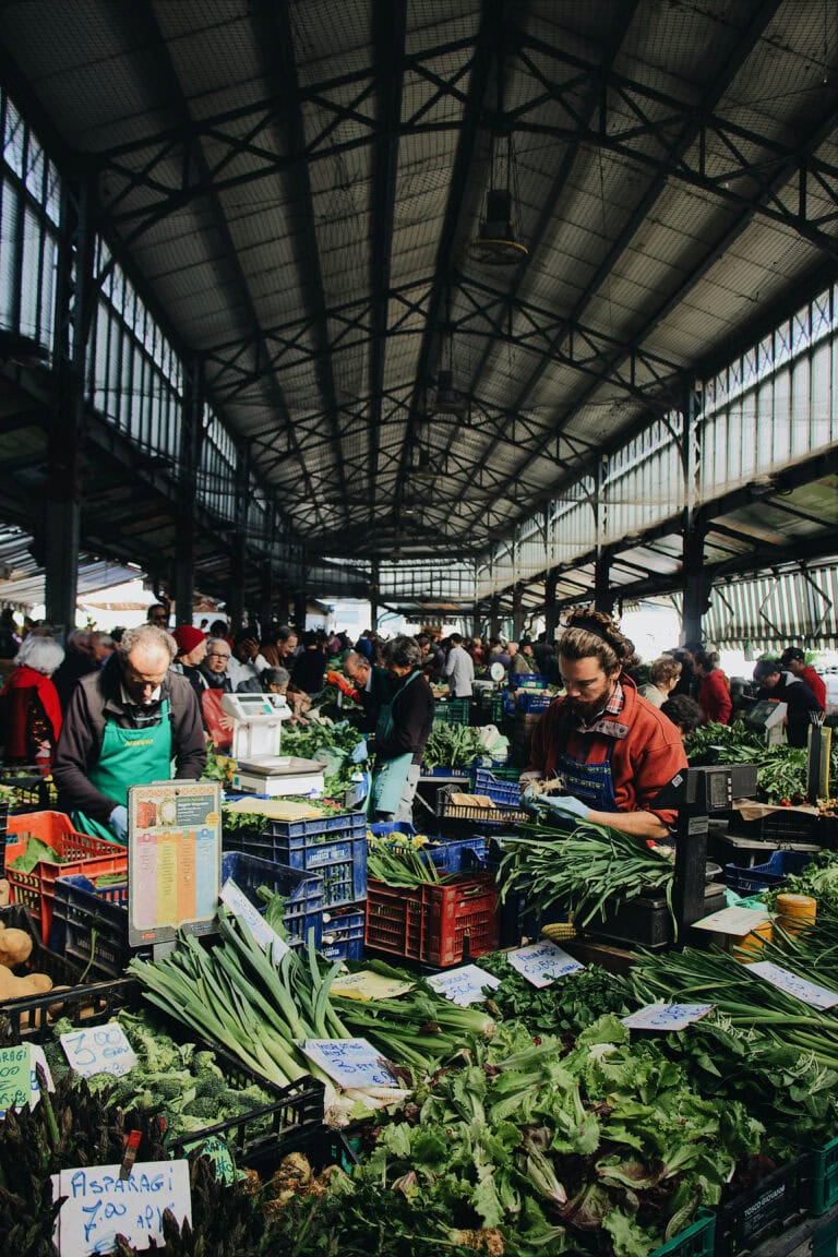 Fresh produce at a busy farmers market for rental listings featuring outdoor shopping spaces.