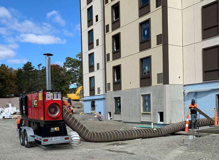 High-capacity construction vacuum excavator on building site for property development and rental projects.