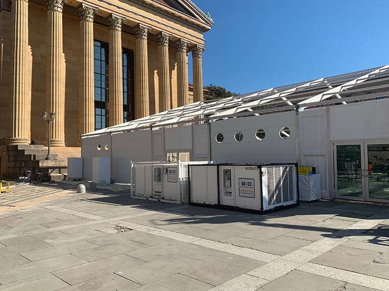 Portable rental units outside government or institutional building for event setup and services.