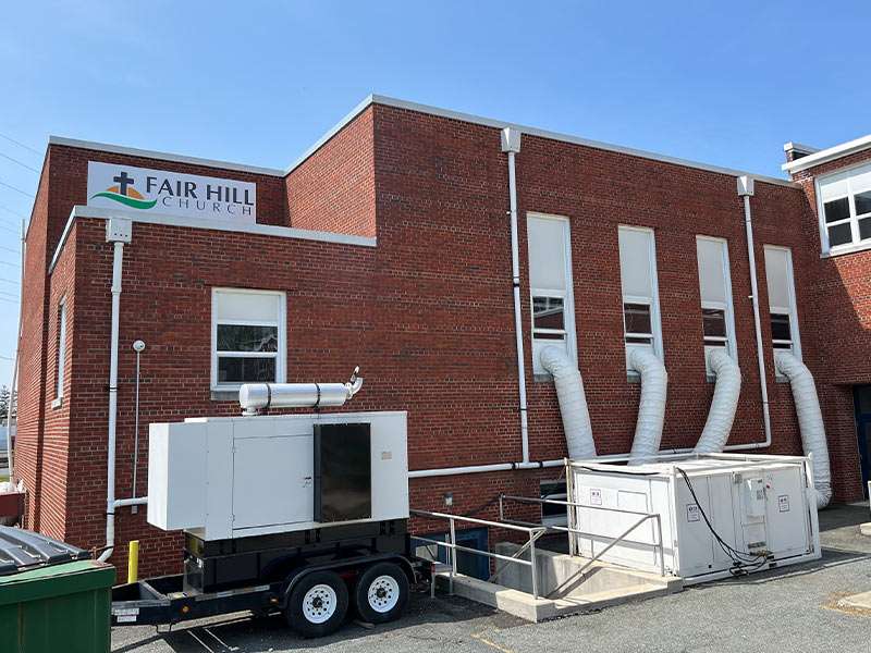 Commercial building HVAC system with ductwork and ventilation units.