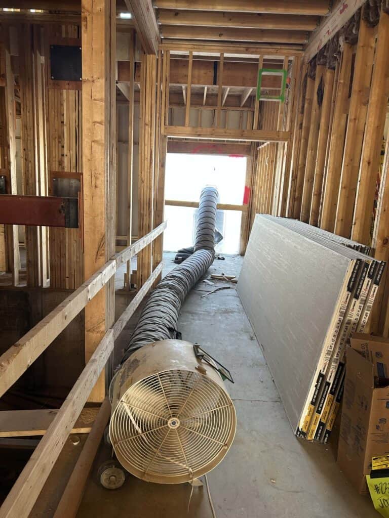 Industrial HVAC ventilation duct installation in under-construction apartment.