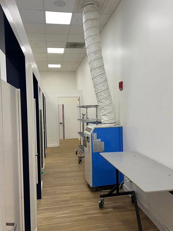 HVAC ductwork and storage carts in commercial space at REIC Rentals.