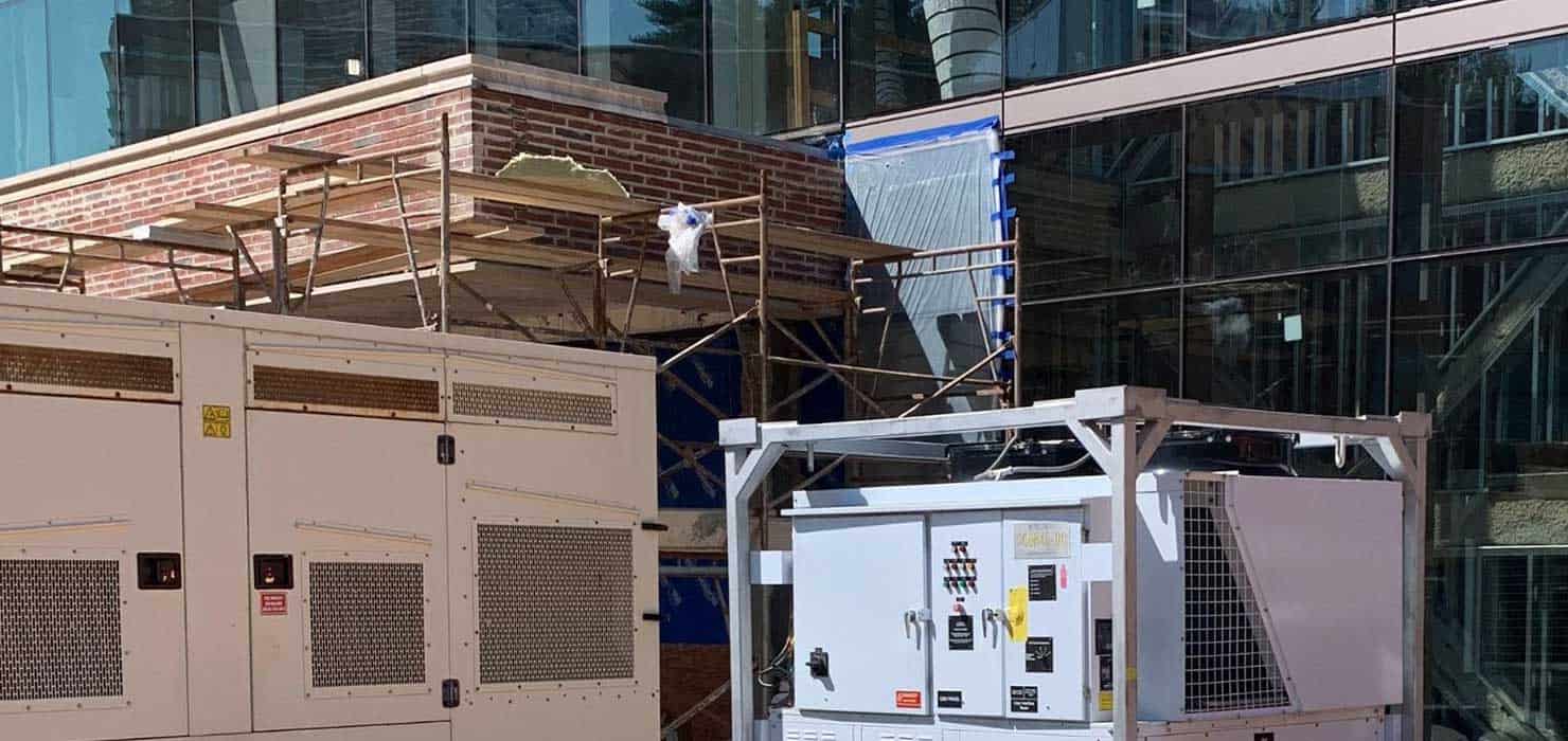Construction site with electrical panels and scaffolding at a rental property.