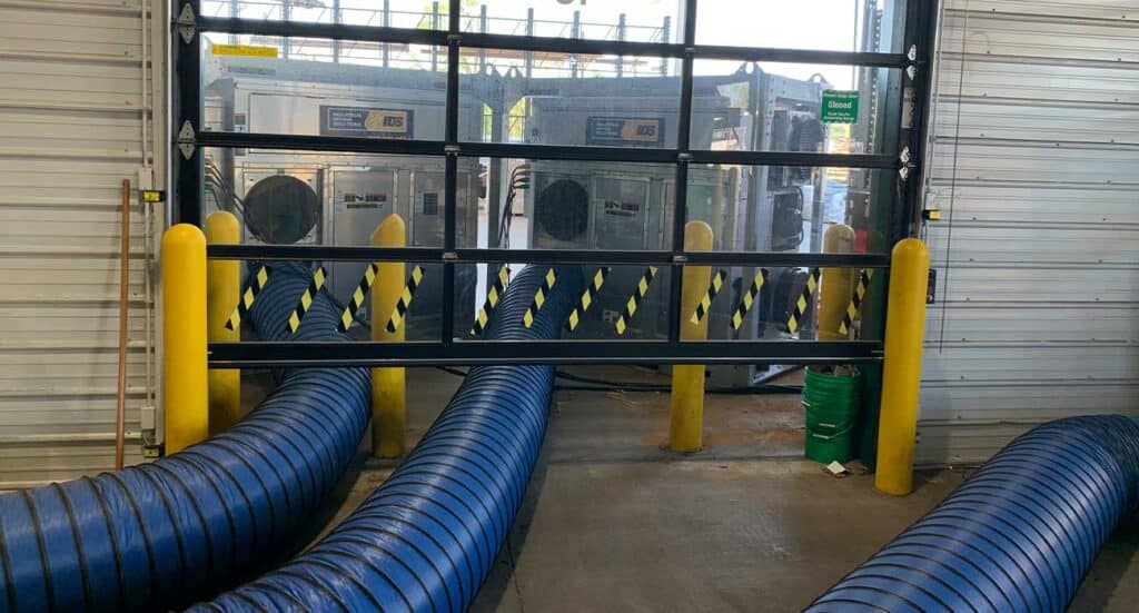Large industrial dryer ventilation hoses at REIC Rentals facility.