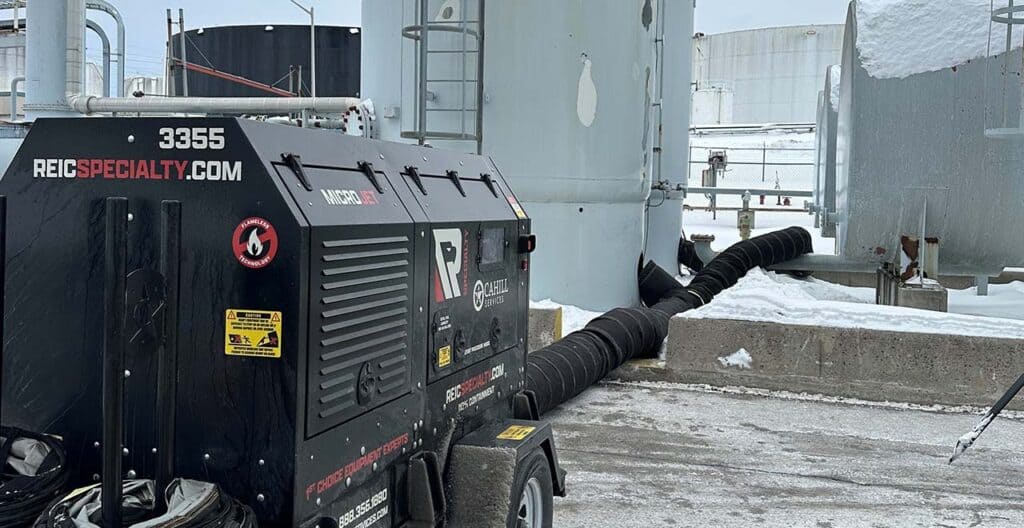 Industrial equipment rental on icy rooftop for construction projects.