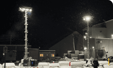 Bright outdoor stadium lighting at night with snow on the ground for REIC Rentals facility.