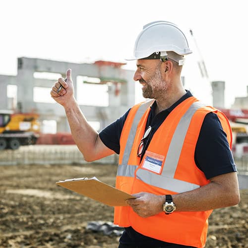 Construction site manager inspecting progress at REIC Rentals construction project.