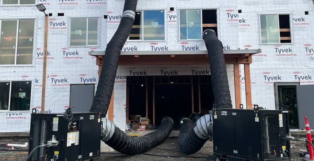 HVAC ductwork setup at construction site to reduce weather delays during Q1.