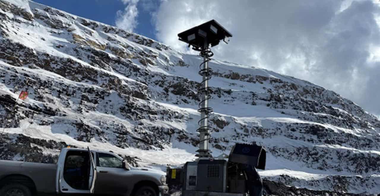 Mobile hybrid light tower on snowy mountain site for winter construction lighting.