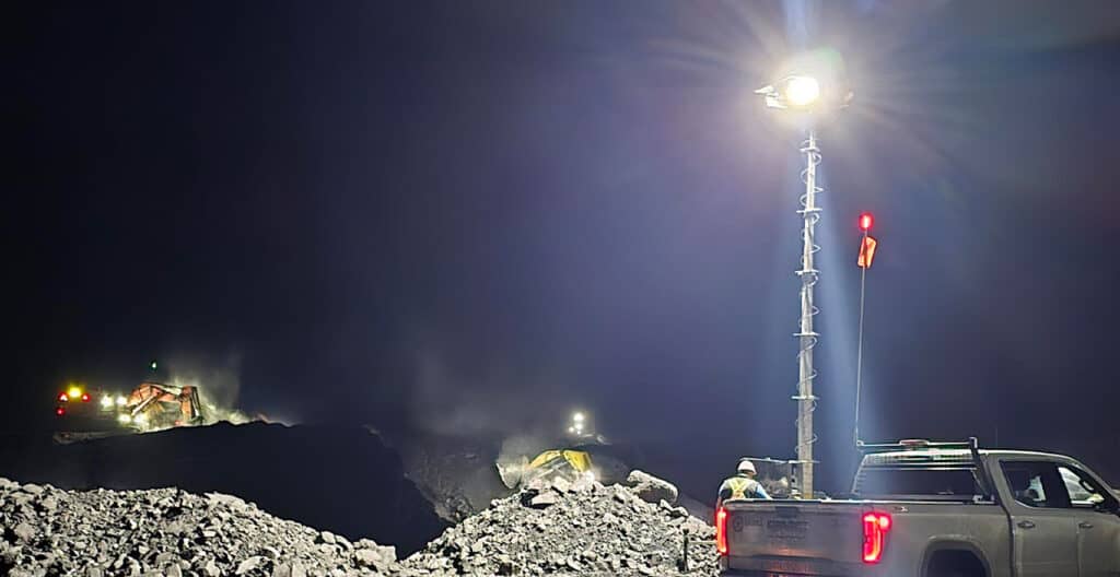 Mining site at night with equipment and lighting for Saskatchewan project.