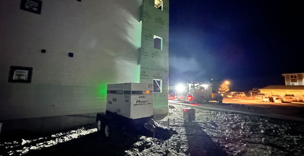 Generator providing backup power for construction site during nighttime operations.