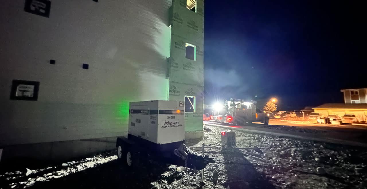 Generator providing backup power for construction site during nighttime operations.