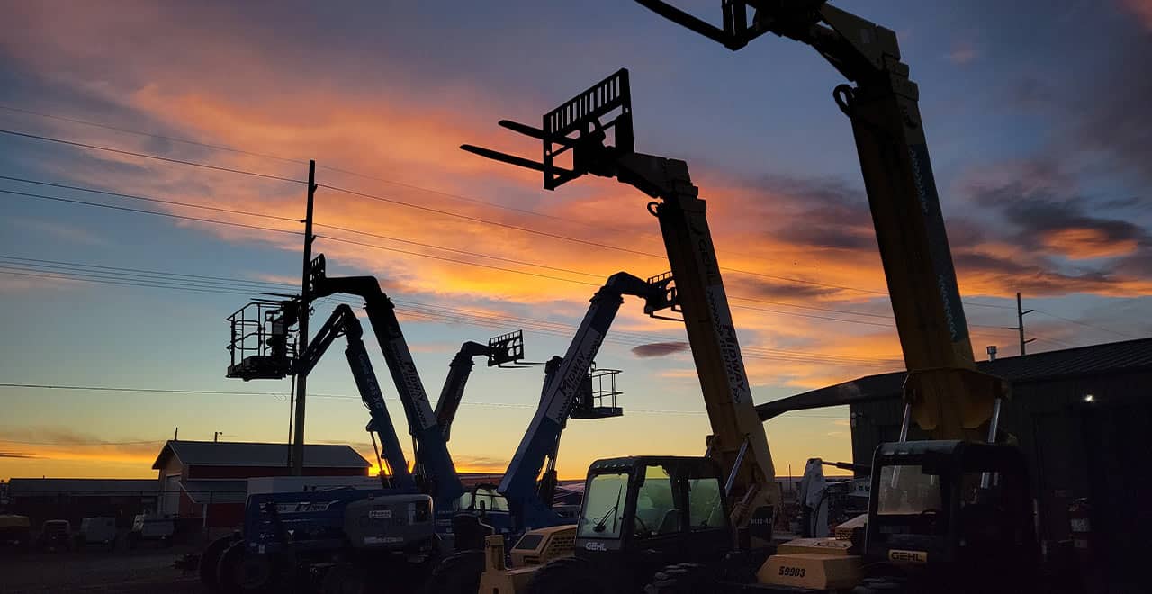 Aerial lift rental fleet at sunset, ideal for construction and maintenance projects.