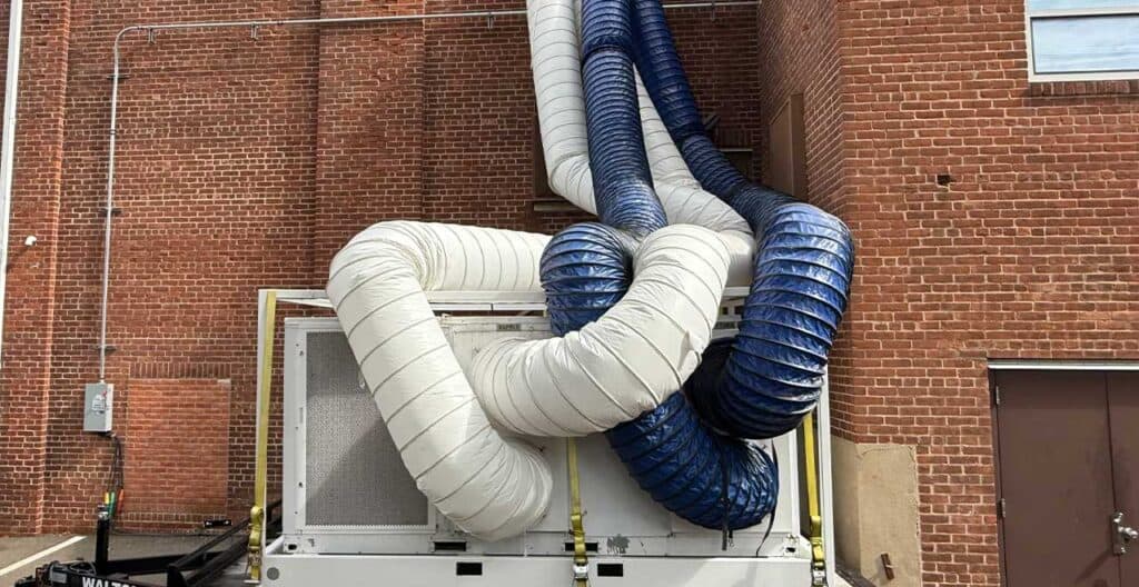 Temporary HVAC duct system for occupied renovation at REIC Rentals.