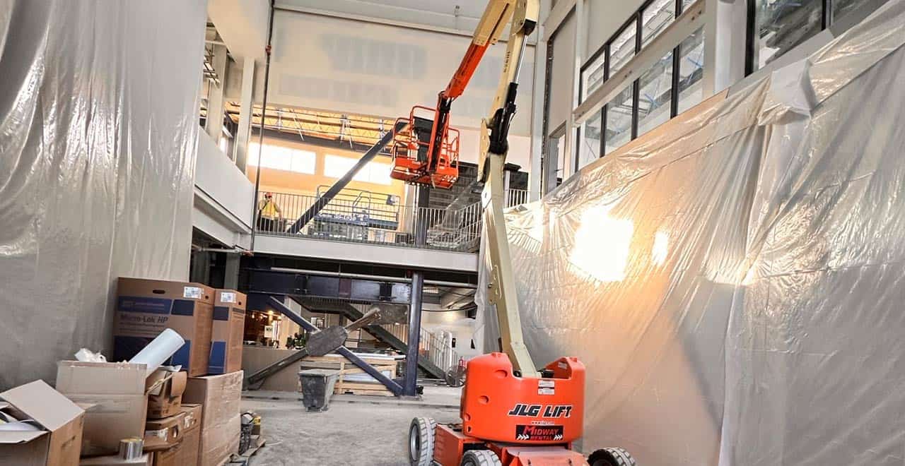 Boom lift in use at a construction site for rental projects, enhancing productivity in Q1.