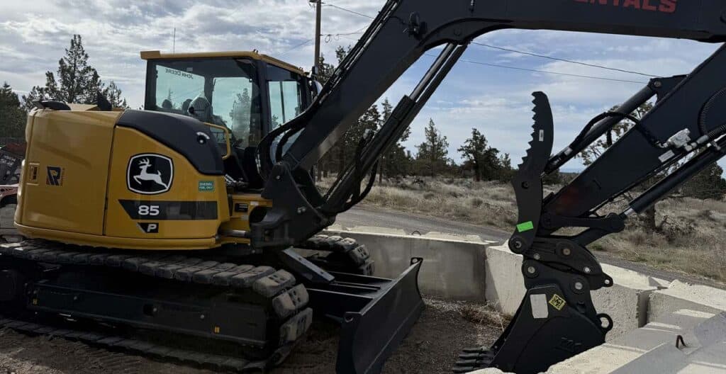 Excavator performing site preparation with compact equipment for efficient material handling.