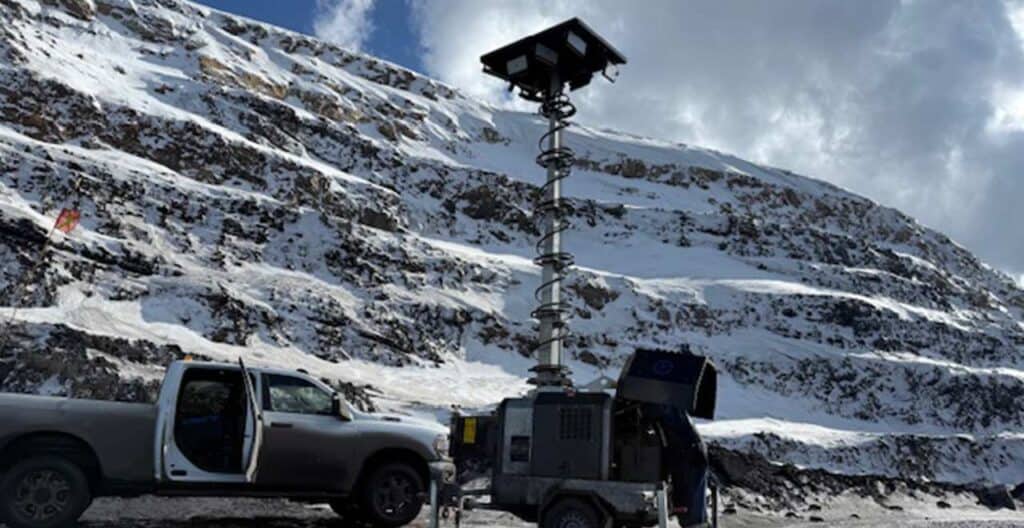Construction equipment on snowy mountain for turnaround season readiness.