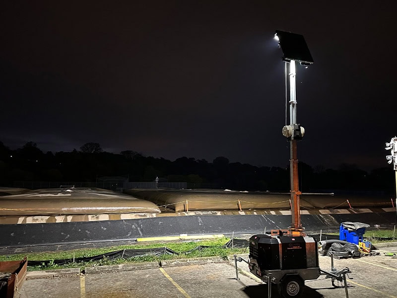 Solar lighting system on a Calgary rooftop at night for REIC Rentals.