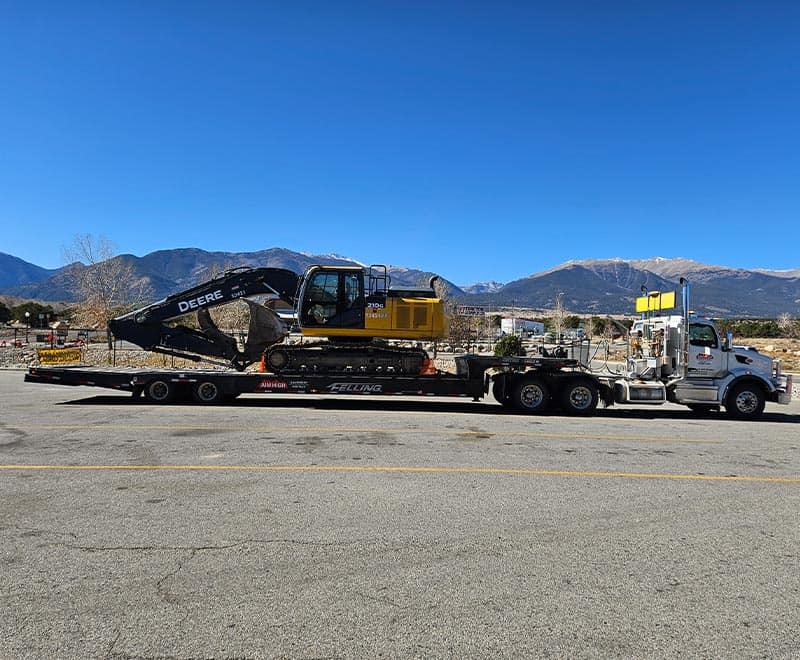 Heavy machinery transport for construction or rental purposes.
