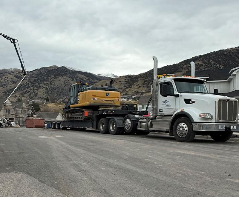 Heavy machinery transportation for construction projects in scenic outdoor locations.
