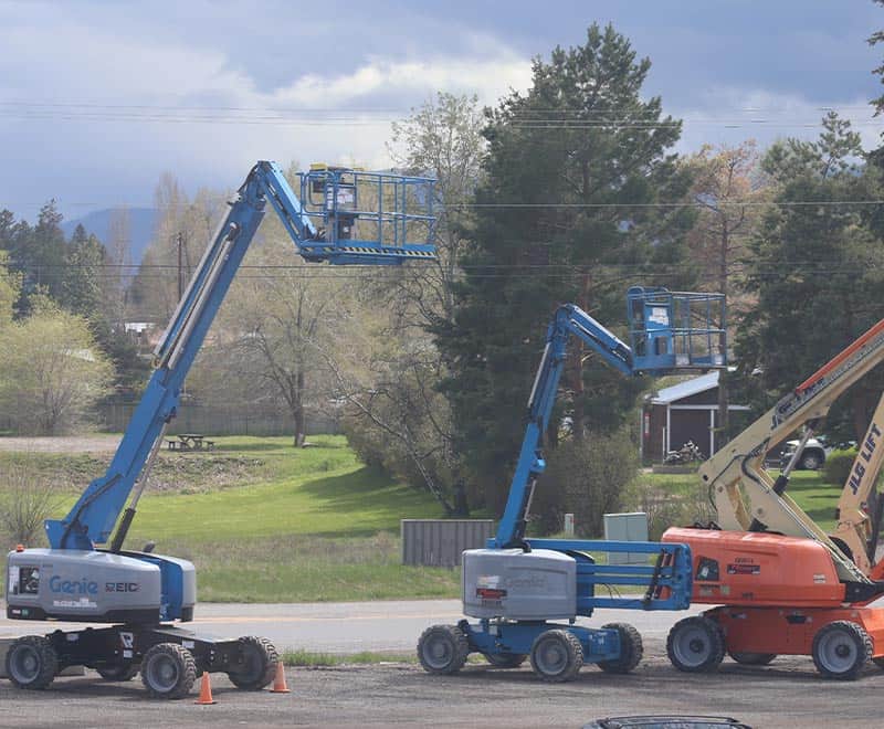 Aerial lift equipment rentals by REIC, featuring blue boom lifts for construction and maintenance pr.