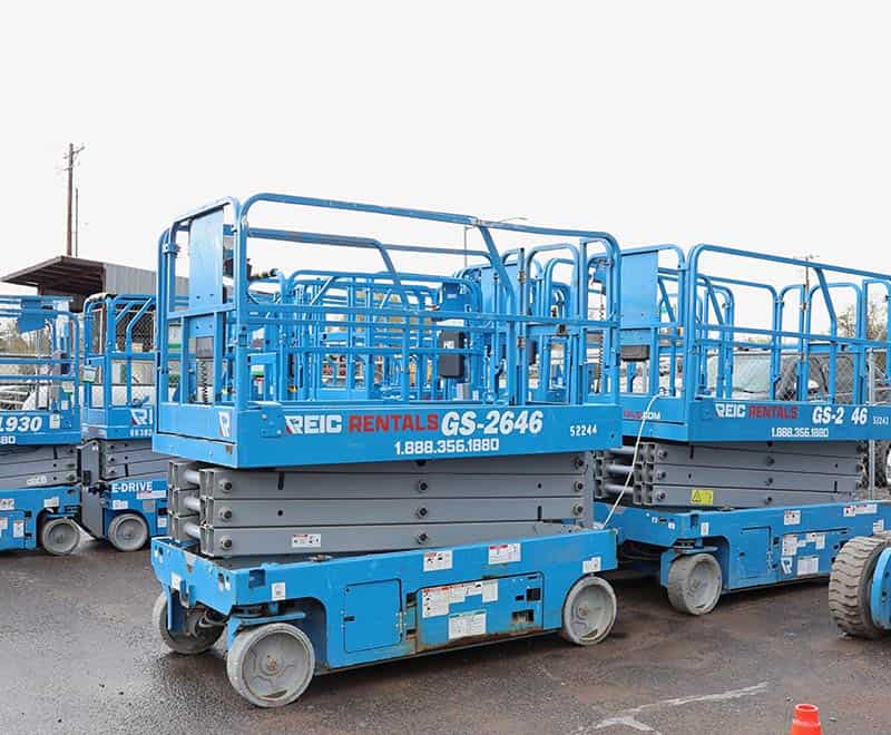 Scissor lift rental equipment in blue, used for construction and maintenance tasks.