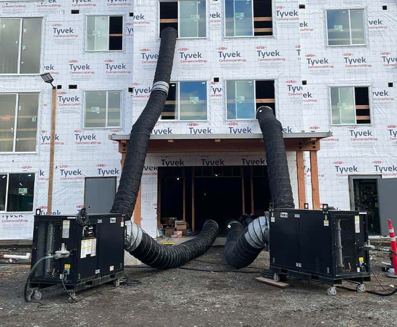 HVAC ductwork installation at a residential construction site.