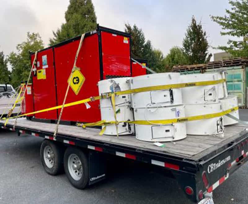 Portable generator and construction equipment on flatbed trailer for rent.