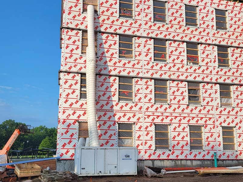 Under construction apartment building in Columbus with insulation wrap.