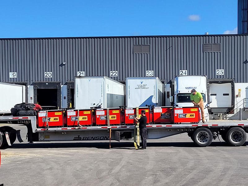 Loading dock with trucks and workers at REIC Rentals in Columbus.