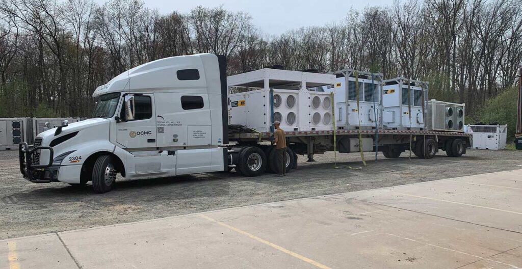 Mobile modular HVAC units on a flatbed truck for rental or installation services.
