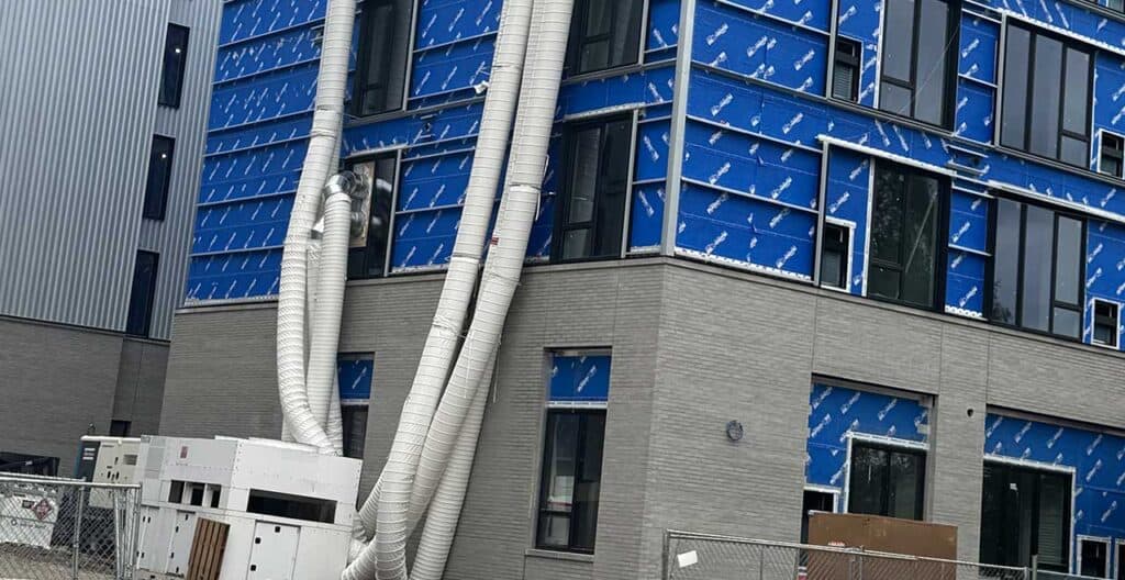 Modern building with dehumidification ducts for construction moisture control.