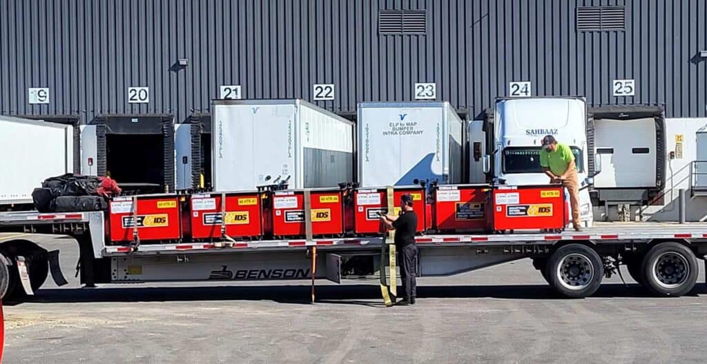 Refrigerated containers on a flatbed truck at REIC Rentals facility.