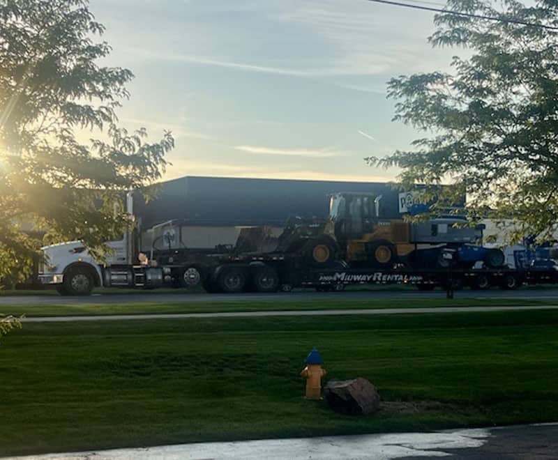 Heavy equipment being transported on a flatbed truck in Missoula.