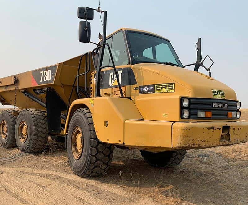 Yellow Caterpillar ERS off-road vehicle on dirt ground in Moses Lake.