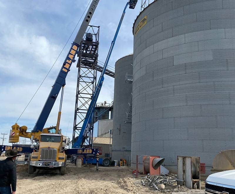 Construction site with cranes and silos in Ontario for REIC Rentals.