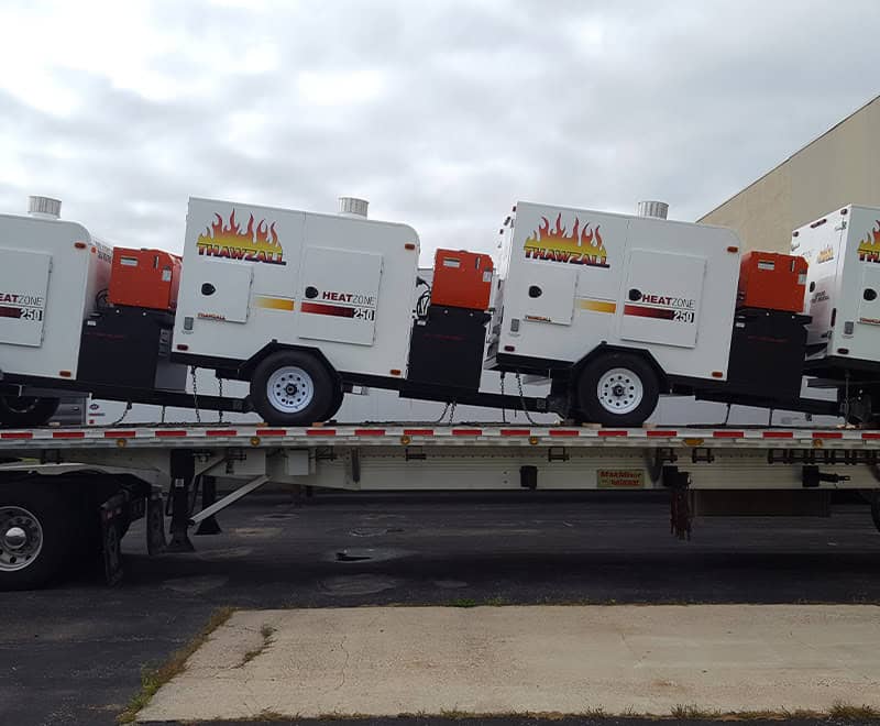 Multiple portable heaters on a flatbed trailer for rental at REIC.