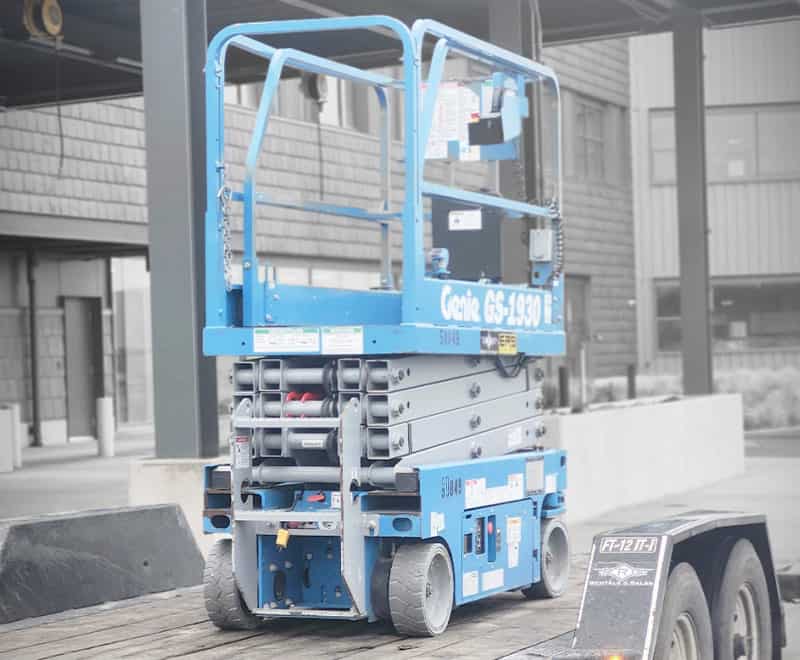 Blue industrial lift platform on a trailer at Portland location.