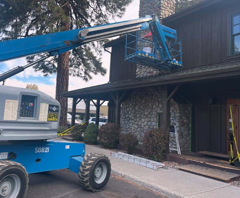 Construction lift working on the exterior of a rental property in Redmond.