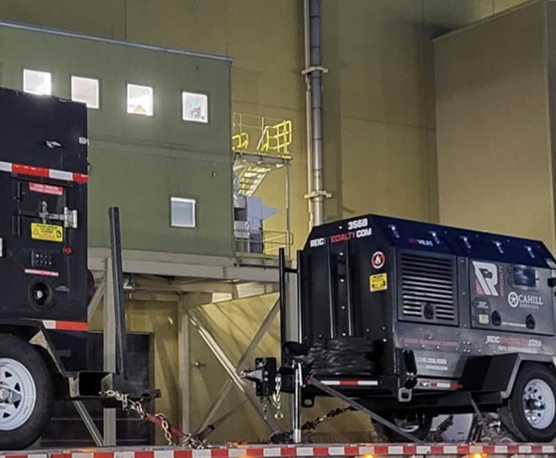 Large industrial generator on trailer at Sudbury site for rental services.