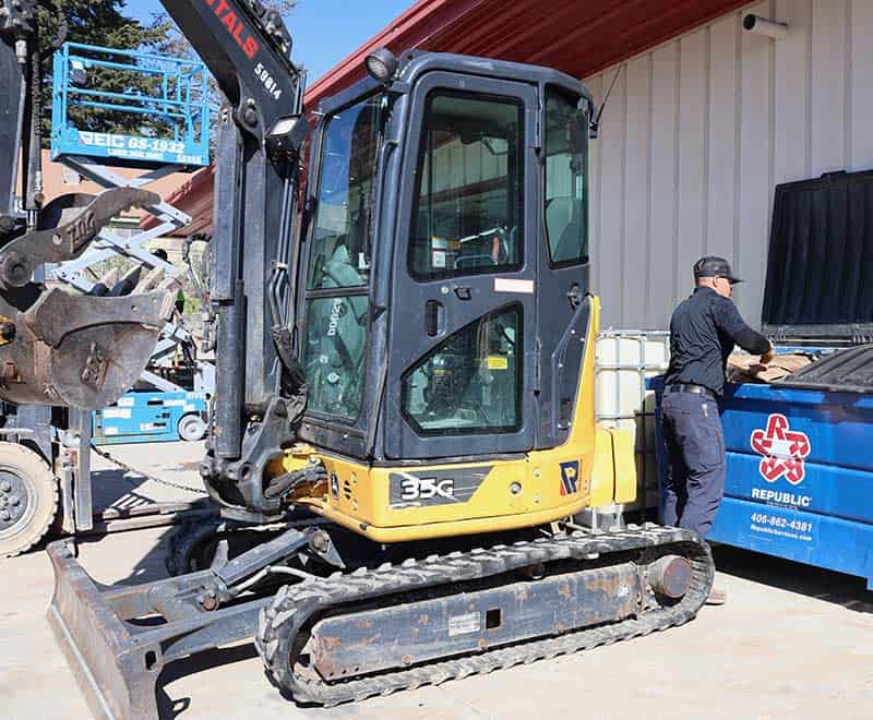 Small yellow compact excavator at REIC Rentals location in Whitefish.