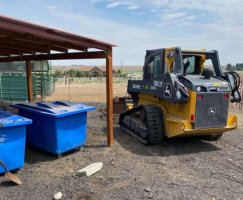 John Deere compact track loader at Yakima rental property.