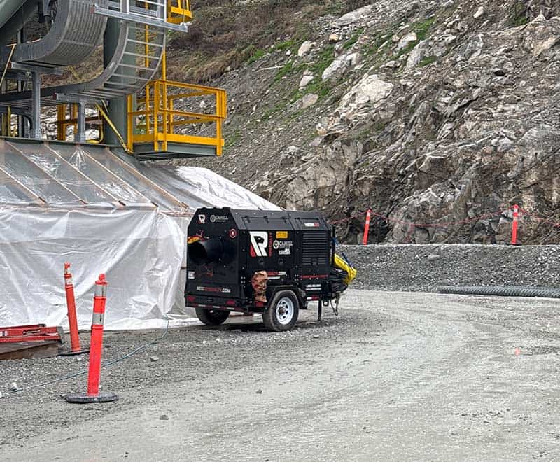 Construction equipment and safety barriers at a work site near Red Deer.
