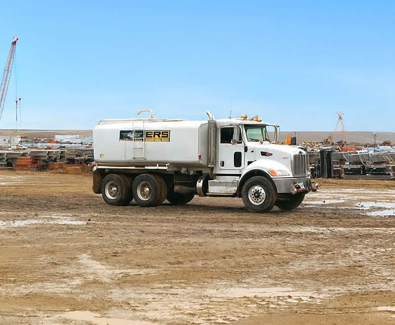 Water truck on construction site in Twin Falls for site preparation.