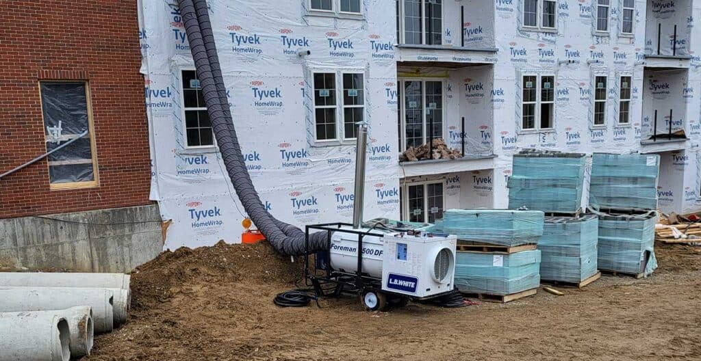 HVAC unit and ductwork at building under construction.