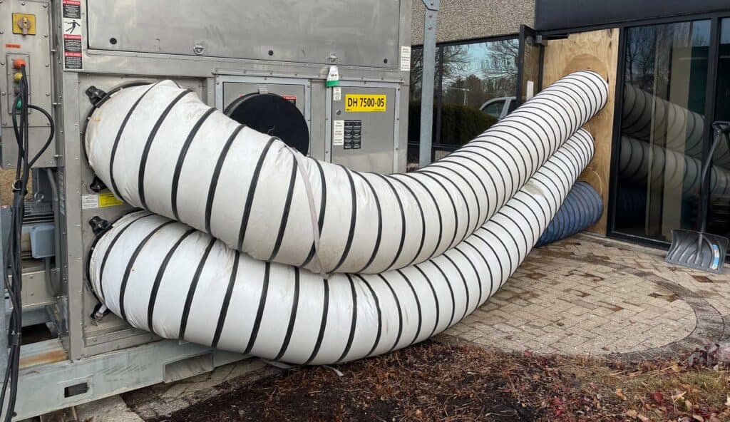 Large flexible HVAC ducts outside a semiconductor facility for moisture control.